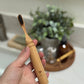 Bamboo handle travel toothbrush with castor oil bristles.