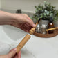Bamboo handle travel toothbrush and castor oil bristles.