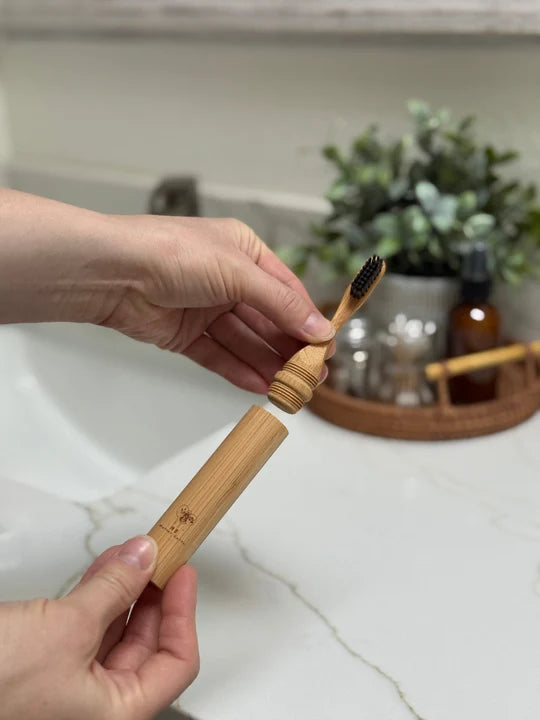 Bamboo handle travel toothbrush and castor oil bristles.